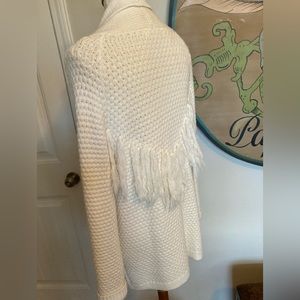 Off white long sleeved sweater w/yarn tassels
